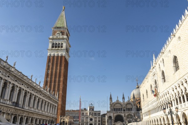 Scenic view of piazza san marco with its famous landmarks, including st. Mark's campanile and doge's palace, under a clear blue sky