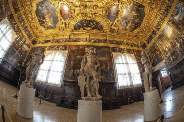 Classical sculptures stand amidst the grandeur of a richly decorated hall within doge's palace, showcasing the opulence of venetian art and architecture