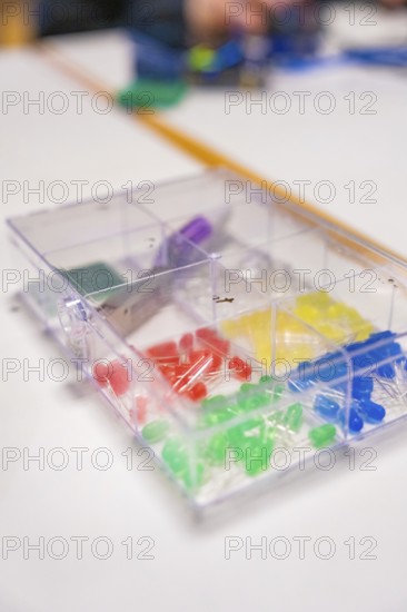 Colourful LEDs and electronic components in a plastic box on a table, Youth Research Centre Nagold, Germany