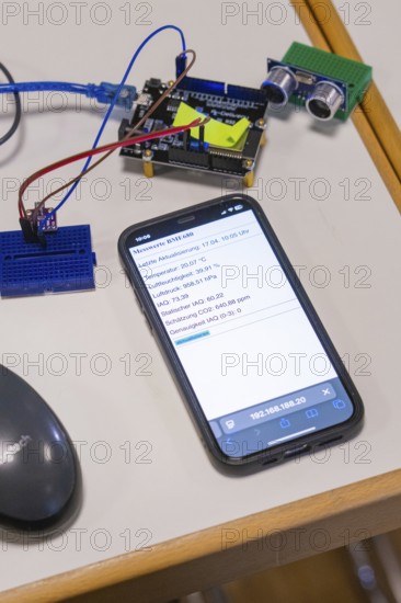 Smartphone on table next to electronic devices, displays measured values, Nagold Youth Research Centre, Germany