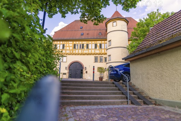 Half-timbered house with courtyard, stairs and parked car, surrounded by trees, Deufringen, Aidlingen, Germany