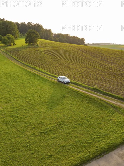Car driving along a green country road through a quiet, rural landscape, Renault Megane, Deer E Carsharing, electric car, Calw, Black Forest, Germany