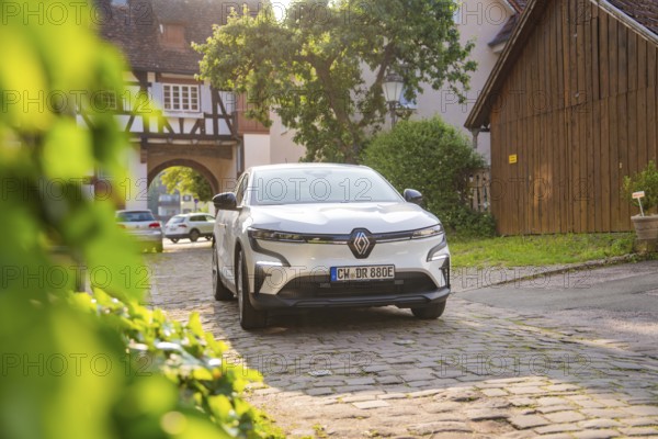 White car parked in an idyllic alley with half-timbered houses and bright sunshine, Renault Megane, Deer E Carsharing, electric car, Calw, Black Forest, Germany