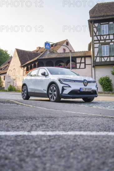 Modern car on an urban street, surrounded by historic half-timbered houses in the warm evening light, Renault Megane, Deer E Carsharing, electric car, Calw, Black Forest, Germany