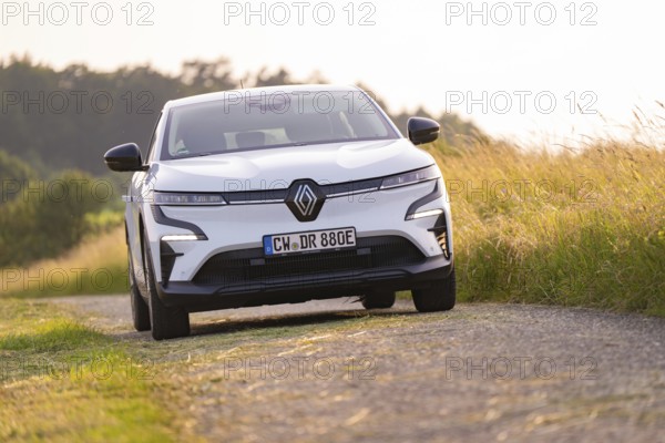 White car driving along a rural road next to a field, Renault Megane, Deer E Carsharing, electric car, Calw, Black Forest, Germany