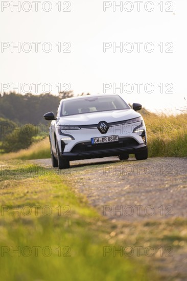 White car driving on a rural road in summer, Renault Megane, Deer E Carsharing, electric car, Calw, Black Forest, Germany