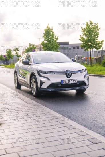 White electric car from Renault parked on a city street under a cloudy sky, Renault Megane, Deer E Carsharing, electric car, Calw, Black Forest, Germany