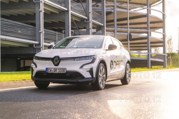 White Renault car standing on a street in front of a car park in the sunlight, Renault Megane, Deer E Carsharing, electric car, Calw, Black Forest, Germany