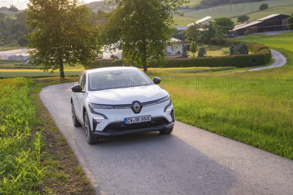 Electric car driving on a rural road, surrounded by green nature and trees, Renault Megane, Deer E- Carsharing, electric car, Gechingen, Germany
