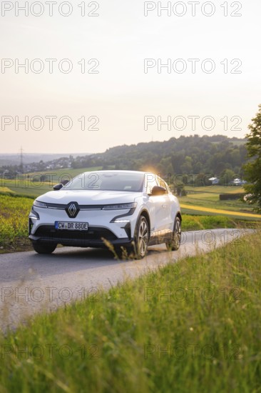 White car driving on a country road in the evening sunshine, Renault Megane, Deer E- Carsharing, electric car, Gechingen, Germany