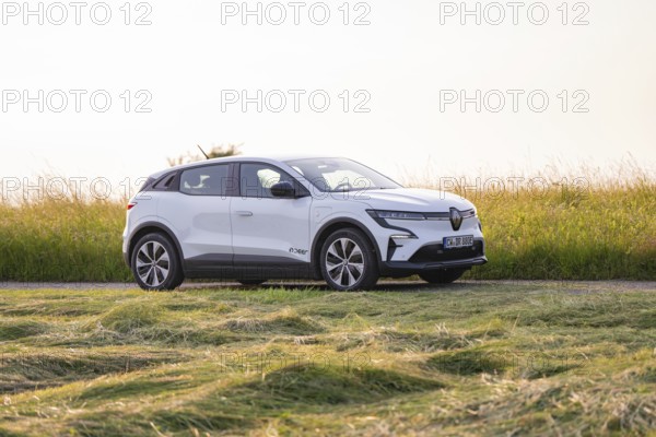 White electric car standing in a meadow on a sunny day, Renault Megane, Deer E- Carsharing, electric car, Gechingen, Germany