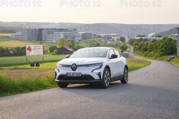 White car parked on a country road with hills and city view in the background, Renault Megane, Deer E- Carsharing, electric car, Gechingen, Germany