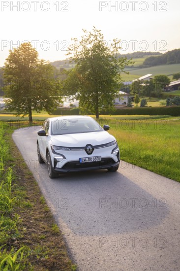 White car driving on a country road at sunset, surrounded by trees, Renault Megane, Deer E- Carsharing, electric car, Gechingen, Germany