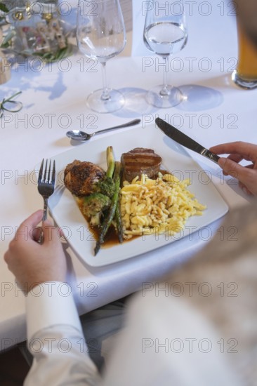 A gourmet plate with meat, asparagus and spaetzle on a festively laid table, event and wedding location Kloster Lorch, Lorch, Germany