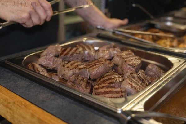 Several pieces of grilled meat in a buffet tray in a kitchen, ready to serve, event and wedding location Kloster Lorch, Lorch, Germany