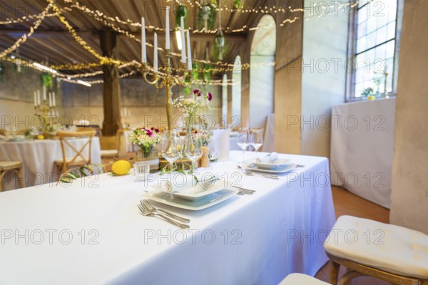 Festively laid table in a room with fairy lights and windows, a warm and inviting atmosphere, event and wedding location Kloster Lorch, Lorch, Germany