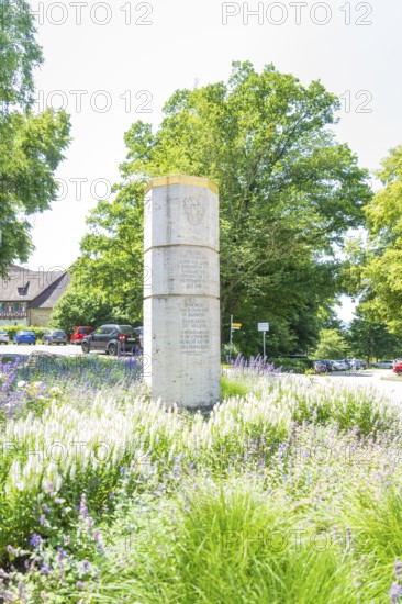 Stone monument surrounded by blooming summer meadows and green foliage, event and wedding location Lorch Monastery, Lorch, Germany