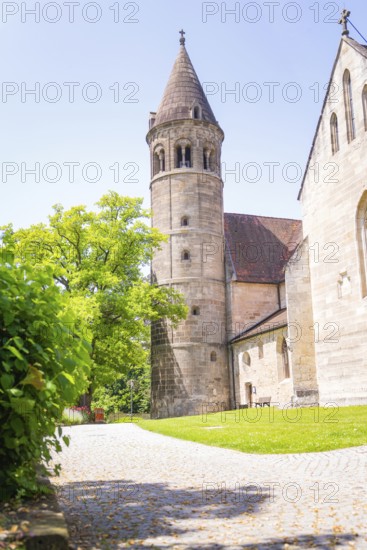 Medieval stone church tower next to a green path in summer light, event and wedding location Lorch Monastery, Lorch, Germany