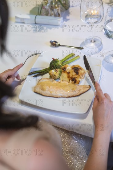 An elegant plate with fish, asparagus and broccoli on a white table, event and wedding location Kloster Lorch, Lorch, Germany