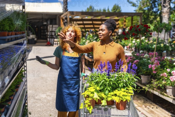 Garden center employee assisting a customer in selecting vibrant plants and flowers for her garden, creating a cheerful shopping experience