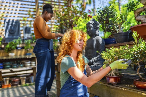 Two young women tending to bonsai trees in a vibrant garden center, enjoying the sunny atmosphere while nurturing their passion for plants