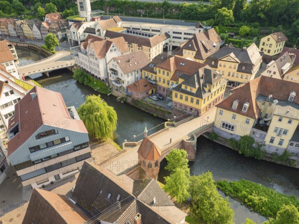 Aerial view of a town with river and many half-timbered houses in sunlight, Calw, Black Forest, Germany