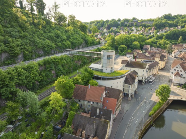 Modern building with a view of an idyllic old town and green hills, Calw, Black Forest, Germany