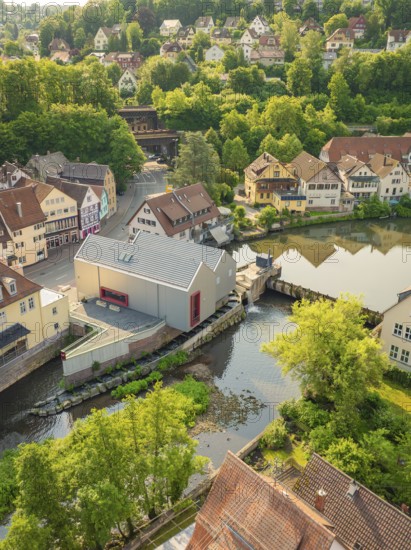 Town view with river and green nature, surrounded by half-timbered houses and trees, Calw, Black Forest, Germany