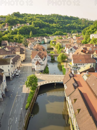 A picturesque town with a river and traditional tiled roofs in summer light, Calw, Black Forest, Germany