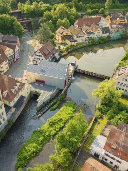 Idyllic town with bridge and green banks along the river, Calw, Black Forest, Germany