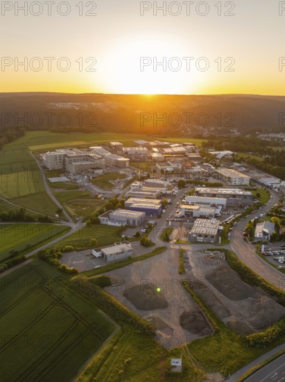 Sunset over an industrial region with surrounding fields and hills, Calw, Black Forest, Germany