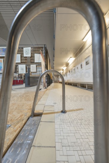 Railing in a gallery corridor with tiled floor and illuminated walls, historical art exhibition in the old swimming pool, Schaudepot, Calw, Black Forest, Germany