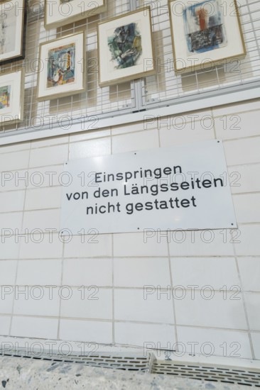 Sign on a tiled wall in a gallery with works of art on display, historical art exhibition in the old swimming pool, Schaudepot, Calw, Black Forest, Germany