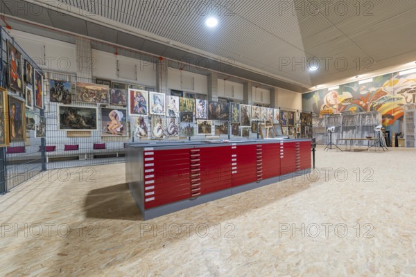 Gallery exhibition with red cabinets and paintings on the wall, historical art exhibition in the old swimming pool, Schaudepot, Calw, Black Forest, Germany