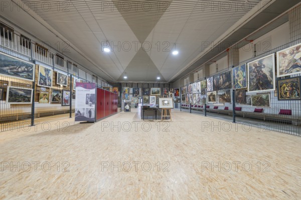 Large exhibition area in an art gallery with paintings on the walls, historical art exhibition in the old swimming pool, show depot, Calw, Black Forest, Germany