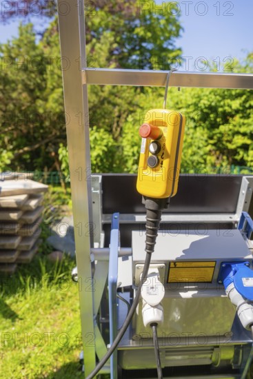 Yellow control unit on a metal frame outdoors in sunny weather, roof renovation, house construction, Pforzheim, Germany