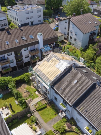 Viewed from above, houses with a partially renovated roof in a green neighbourhood, roof renovation, house construction, Pforzheim, Germany