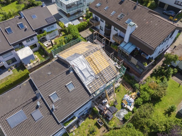 Houses in suburban location with a roof under construction seen from the air, roof renovation, house construction, Pforzheim, Germany