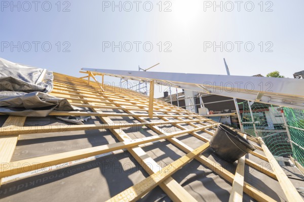 Wooden construction of a roof under construction in sunny weather, roof renovation, house construction, Pforzheim, Germany