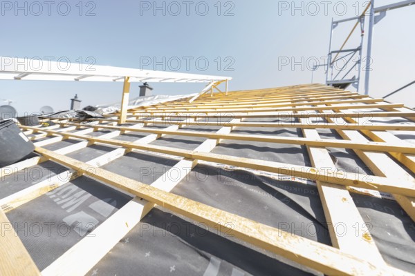 Wooden structure of a roof under construction against a clear sky, roof renovation, house construction, Pforzheim, Germany