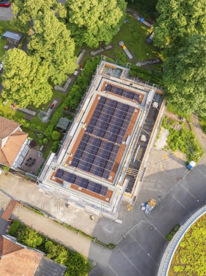 Aerial view of a building with a solar system on the roof, green surroundings, Hirsau, Calw, Germany