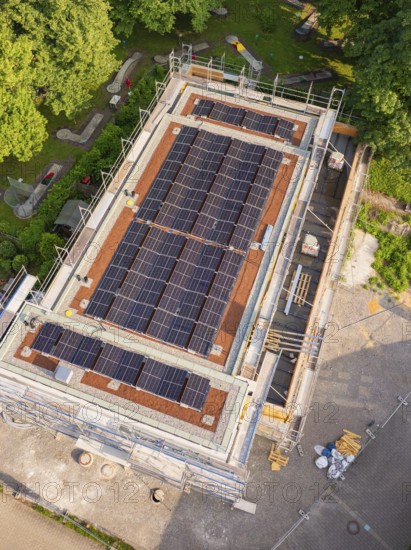 Close-up of a roof with installed solar cells on a construction site with scaffolding in summery surroundings, Hirsau, Calw, Germany