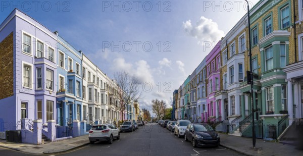 Traditional colorful terraced houses lining a street in notting hill, a popular neighborhood in london, uk, known for its vibrant atmosphere