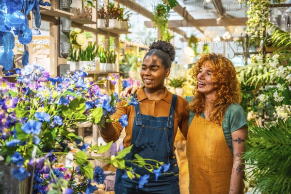 Two young florists arranging vibrant flowers in a charming flower shop, engaging in cheerful discussion while smiling at each other