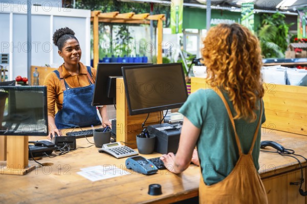 Garden center cashier processing a customer's purchase, creating a positive and efficient shopping experience