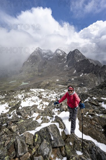 Mountaineers in a rocky mountain landscape, ascent to the Keeskopf from the Niedere Gradenscharte, behind the summit of the Petzeck, Hoher Perschitzkopf and Kruckelkopf, Schober group, Hohe Tauern National Park, Carinthia, Austria