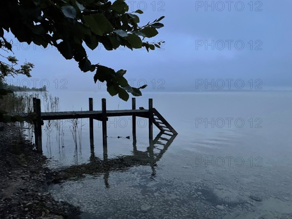 Shore area with jetty on Lake Starnberg, thunderstorm atmosphere, Bavaria, Germany