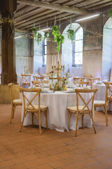 Atmospheric wedding room with round tables and subtle light decorations, event and wedding location Lorch Monastery, Lorch, Germany