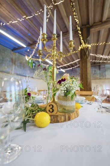 Detailed table decoration with candlestick and licence plate, surrounded by fresh flowers, event and wedding location Kloster Lorch, Lorch, Germany