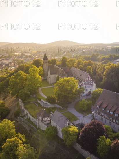 Old church and building on a hill surrounded by trees, event and wedding location Lorch Monastery, Lorch, Germany